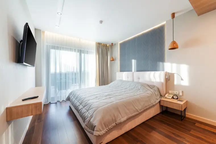 Bedroom with parquet-pattern laminate flooring