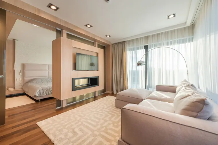 Living room with laminate flooring and a cushioned couch