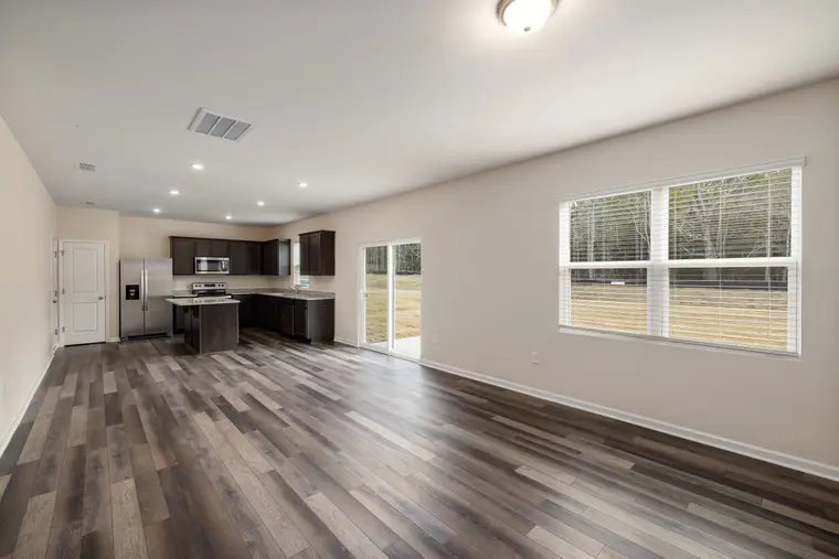 Open-plan kitchen and living room with wood-look laminate flooring
