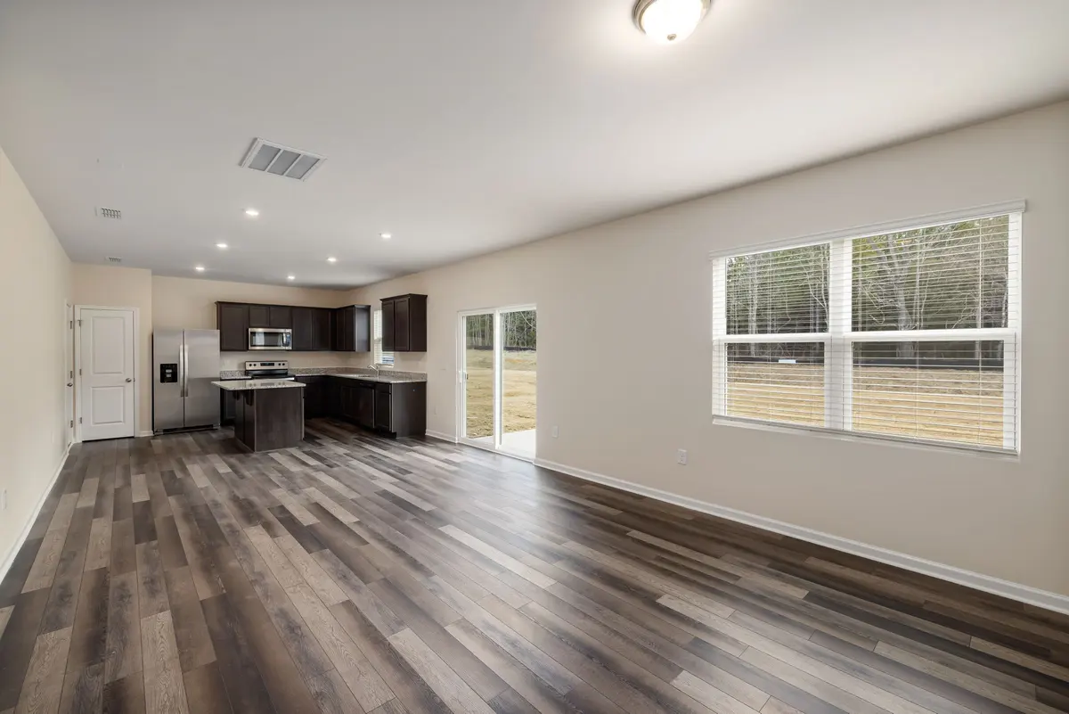 Open-plan kitchen and living room with wood-look laminate flooring