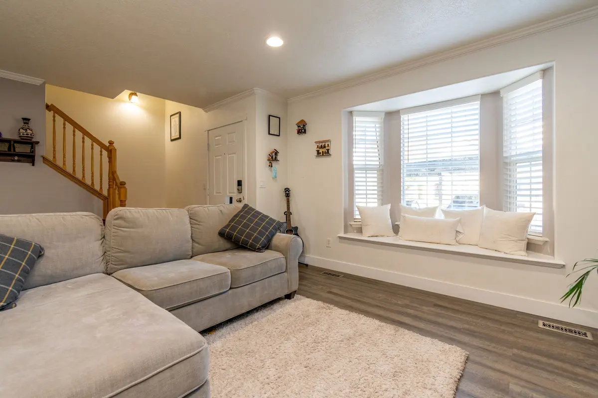 Living room with luxury vinyl plank flooring and a beige sofa