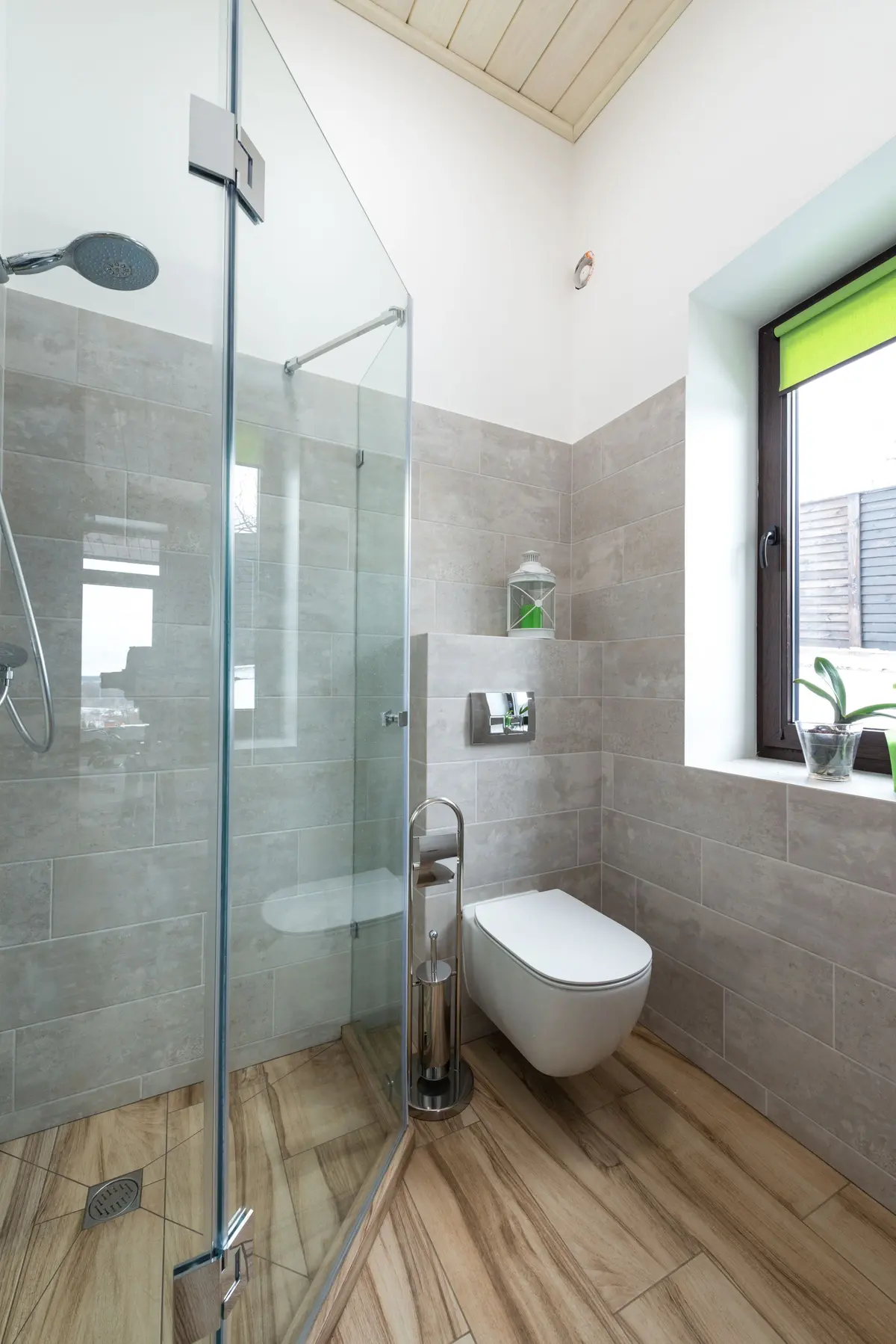 Bathroom with waterproof luxury vinyl plank flooring and a glass shower screen