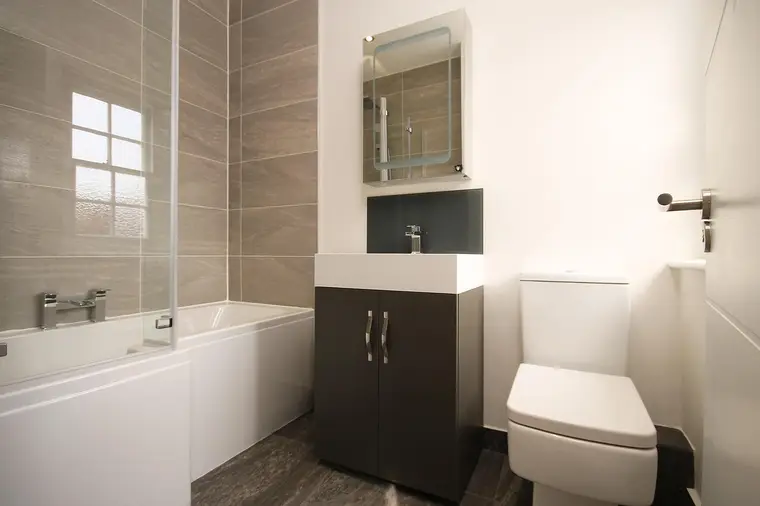Modern tiled bathroom with a bath and basin