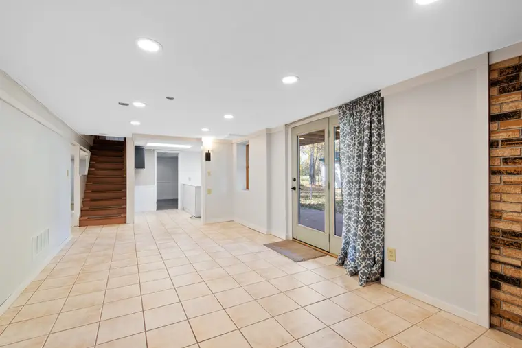 Basement room with tiled flooring and glazed doors