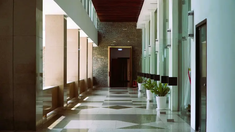 Corridor laid with geometric patterned floor tiles