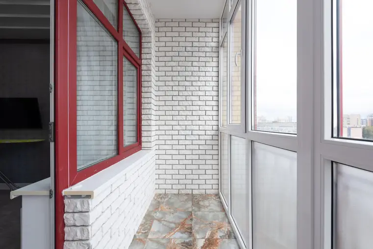 Light-filled room with a stone tiled floor and panoramic glazing