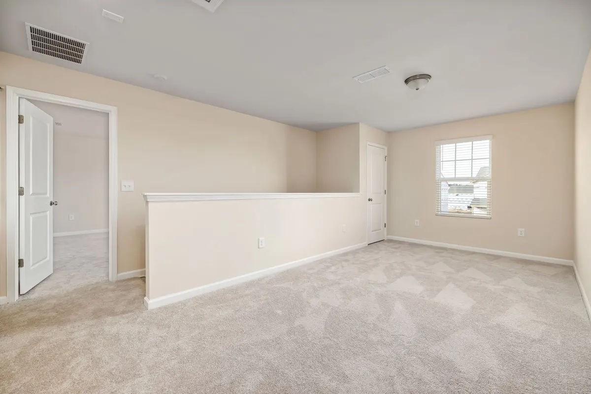 Newly carpeted room with beige walls, ready for furniture to move back in