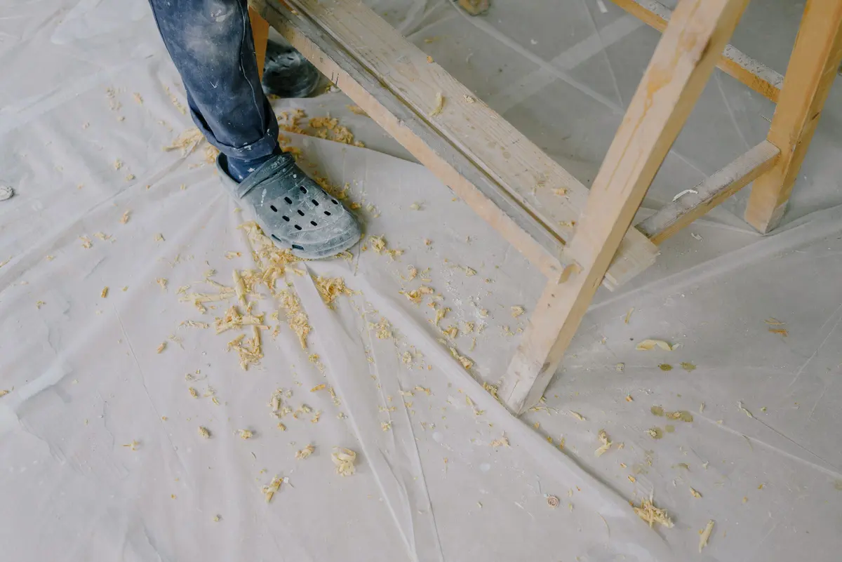 Installer working at floor level during a subfloor preparation