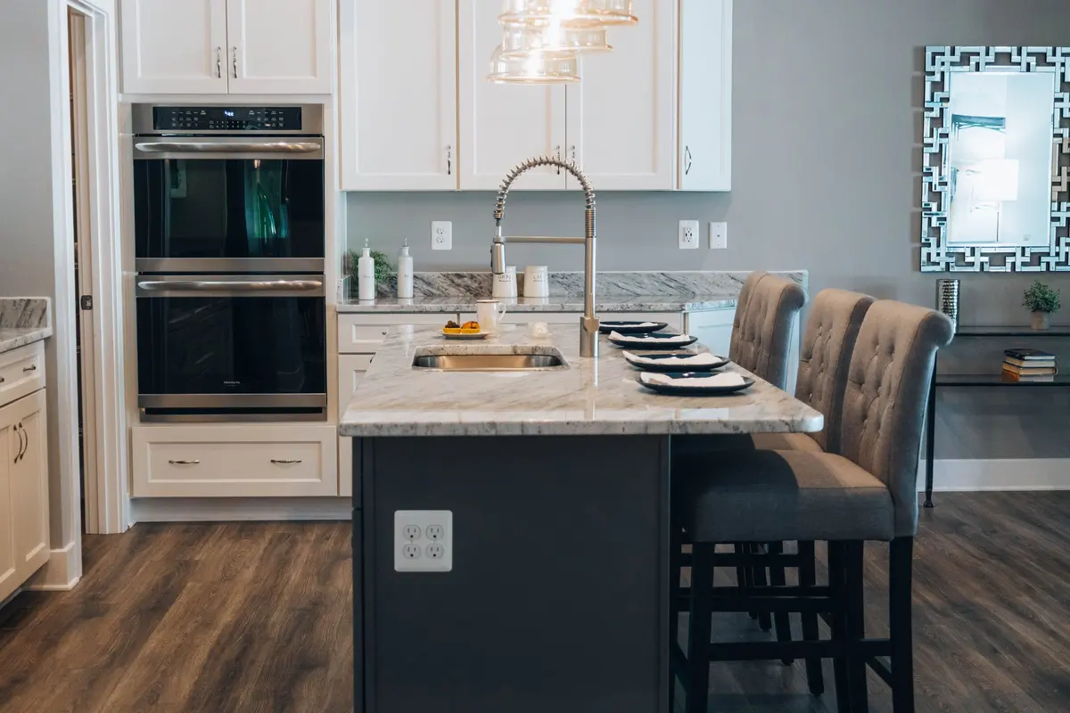 Kitchen with a veined stone island and matching worktops
