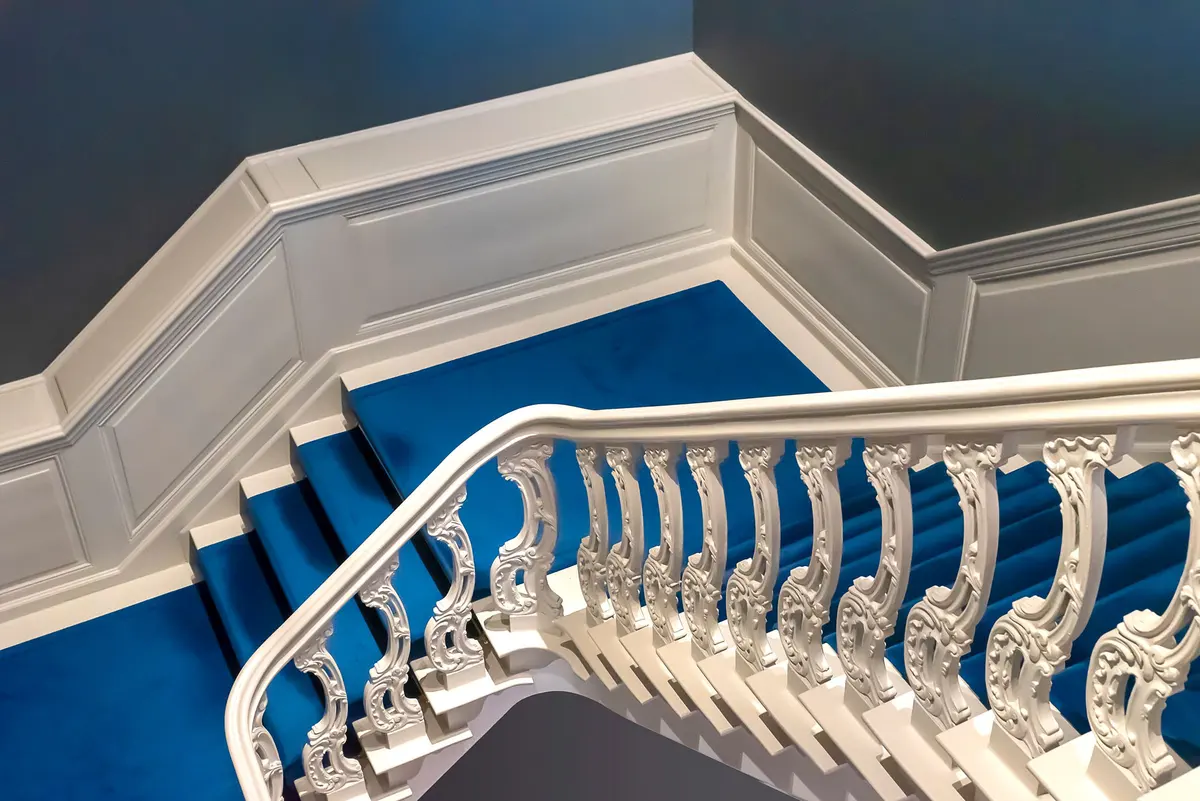 White painted staircase with detailed trim work