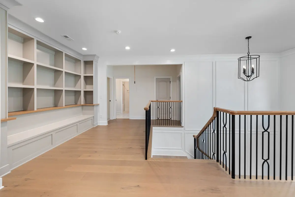 Entrance foyer with wood-look flooring and a custom staircase