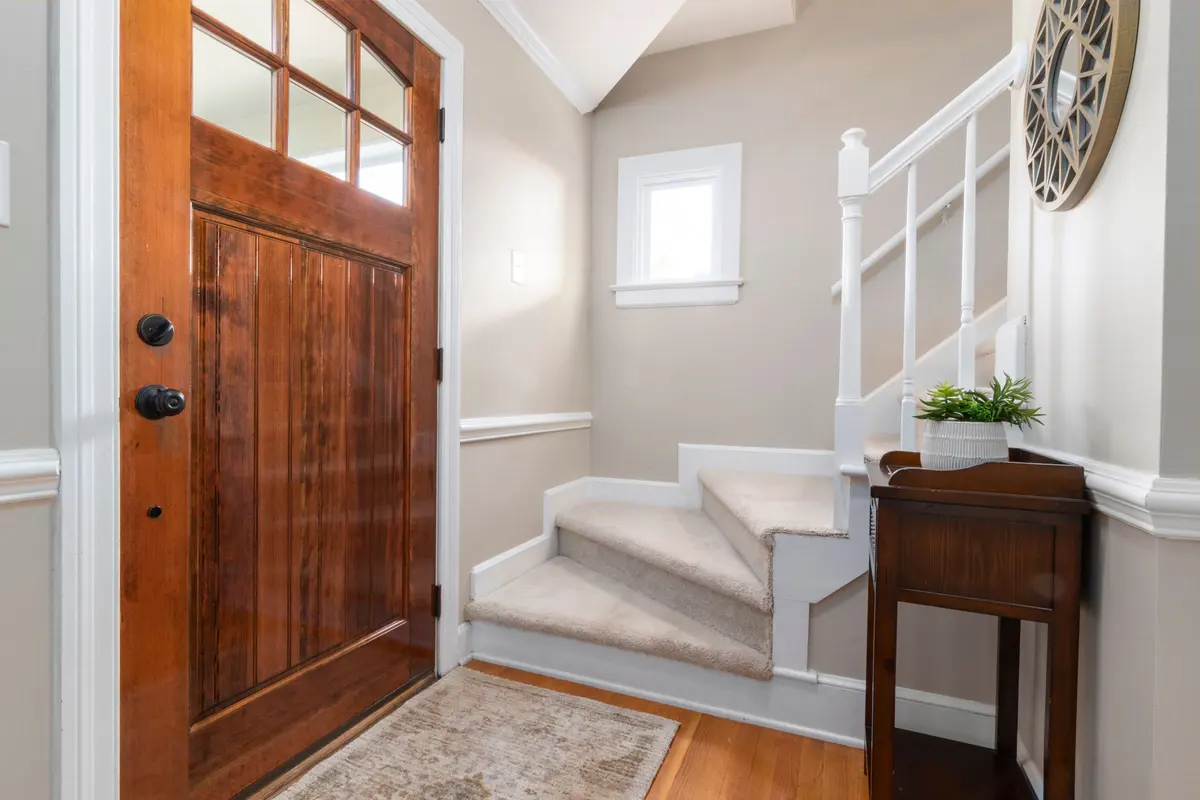 Home entrance with wood-look flooring and matching trim