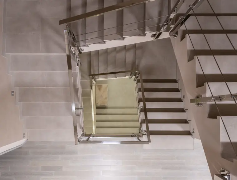 Flights of stairs with metal handrails seen from above